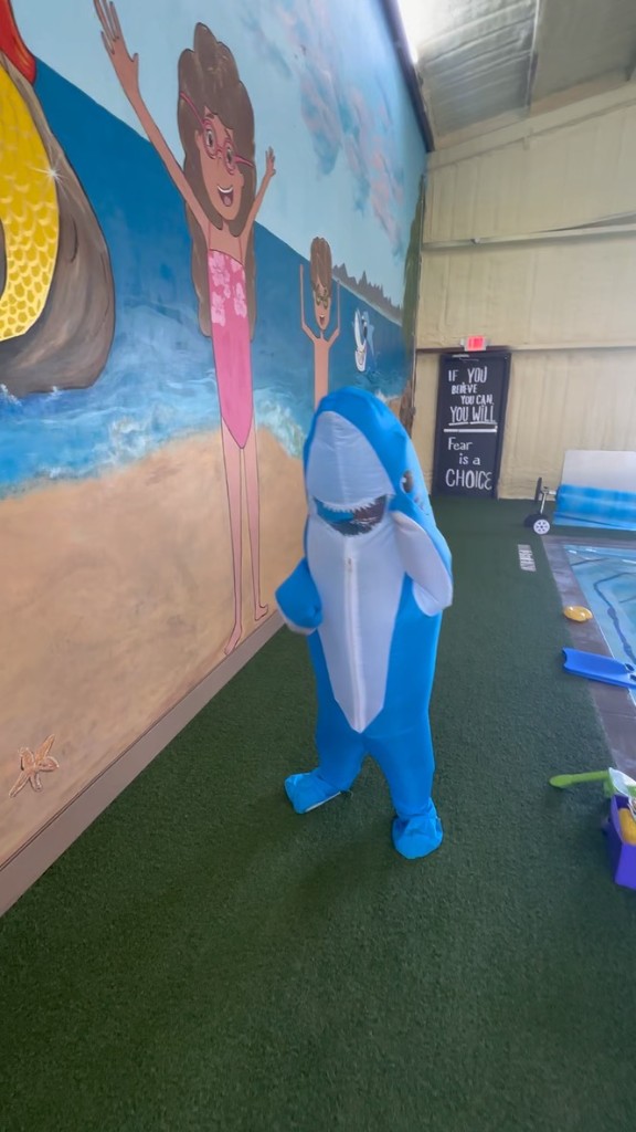 Swimming Fishies shark mascot by the pool mural