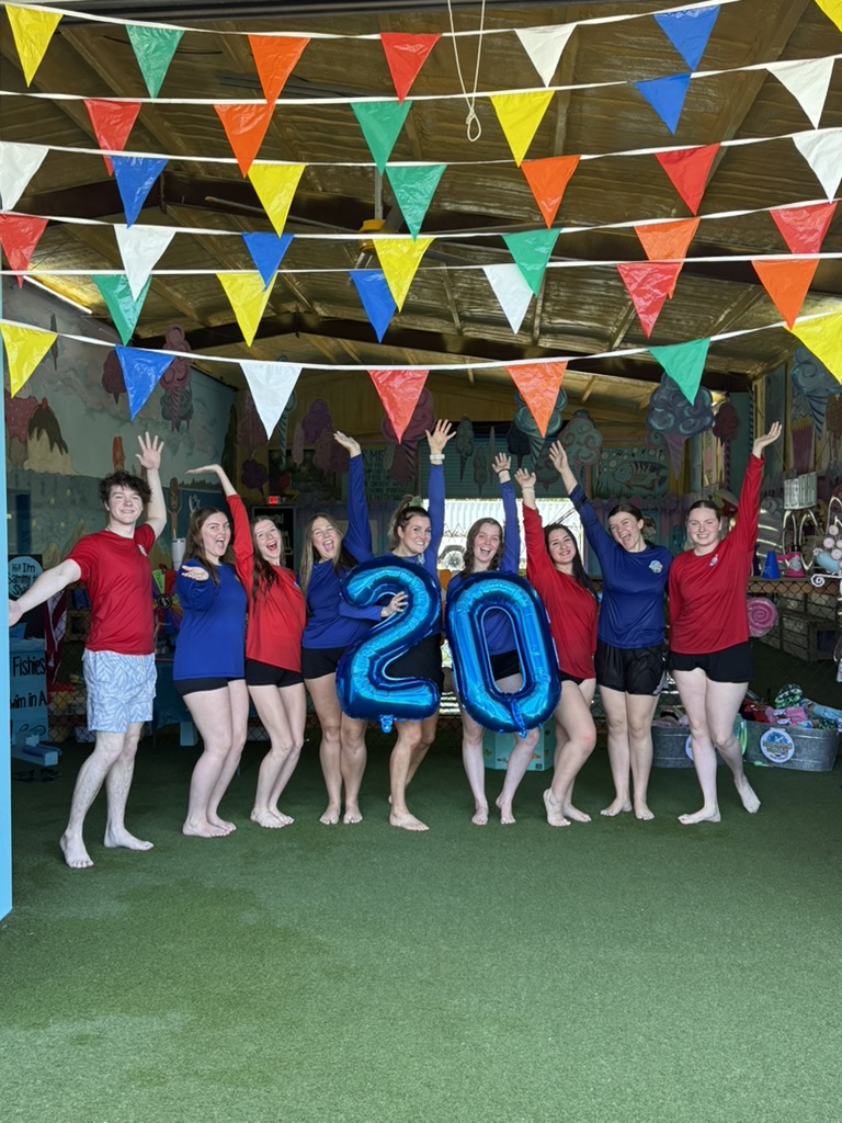 Swimming Fishies coaches celebrating 20 years by the pool