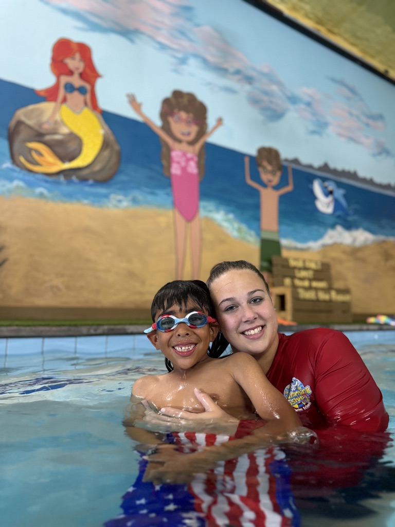 Swim instructor holding a student in the pool