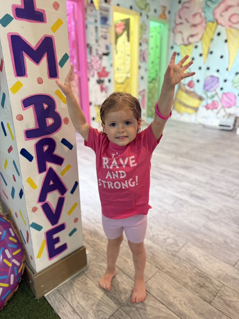 Young swimmer standing proudly in the decorated lobby